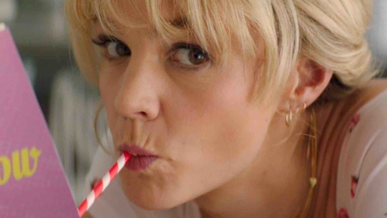 Girl drinking book straw