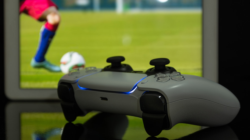 PS5 controller with game behind
