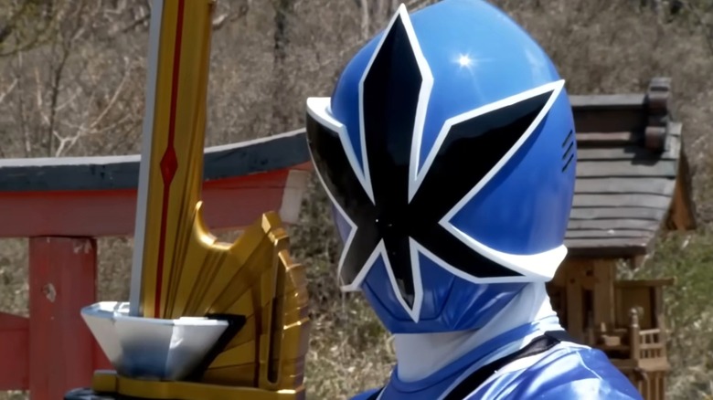 Blue samurai power ranger holds gold sword
