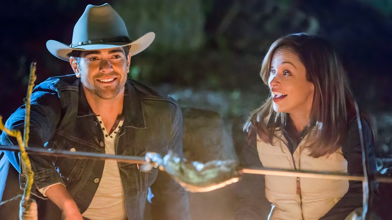 Bradley and Sarah talking at a campfire 