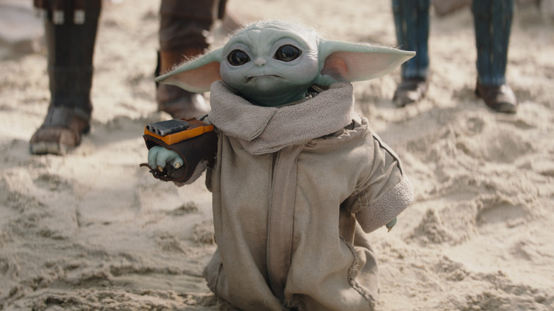 Grogu practicing with a wrist blaster in The Mandalorian (2019)
