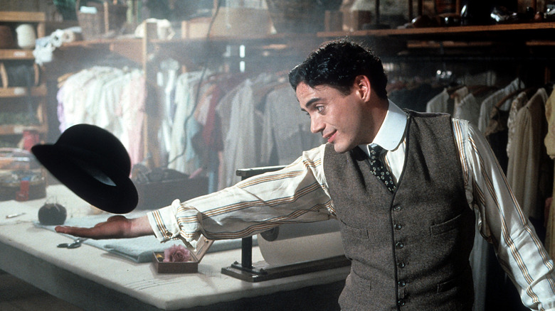 Charlie Chaplin grabs hat