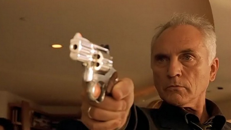 Terrance Stamp holding gun