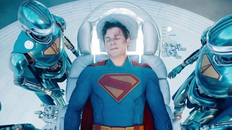 A wounded Superman being tended to by his robots in "Superman" (2025)