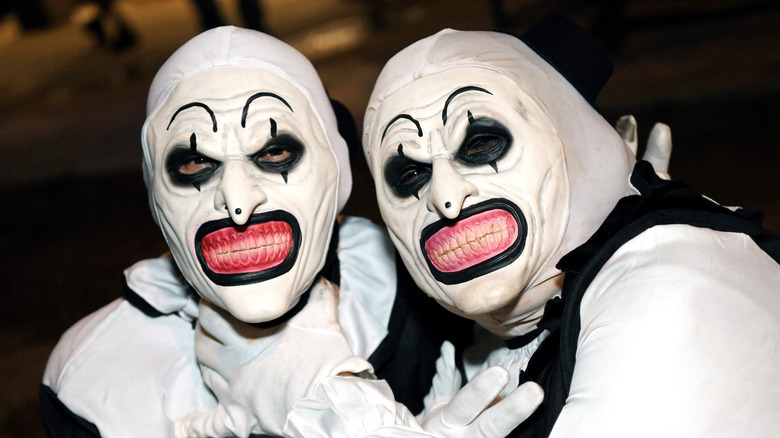 Two people dressed as Art the Clown from "Terrifier"