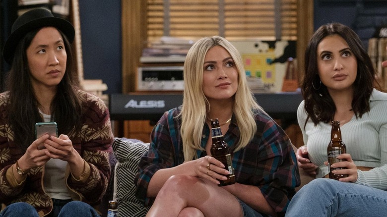 Ellen, Sophie, and Valentina sit on a couch looking up