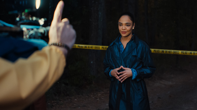 Anna being filmed next to crime scene tape in 