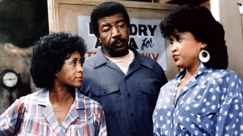 Three of the leads having a contentious doorway conversation in "227" (1985)