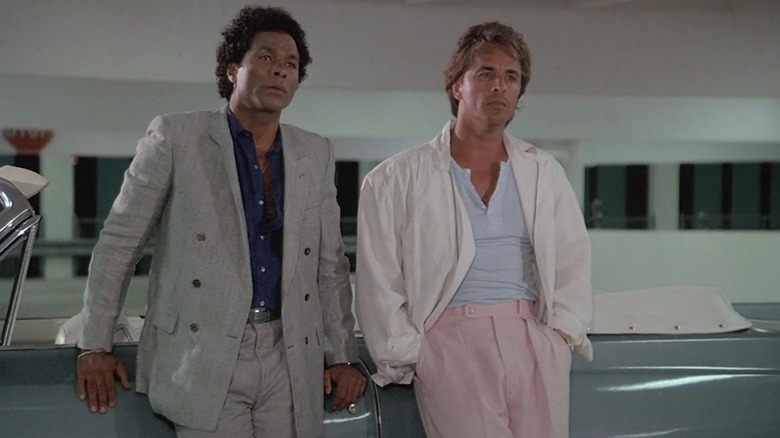 Tubbs and Crocket leaning on a car in "Miami Vice"