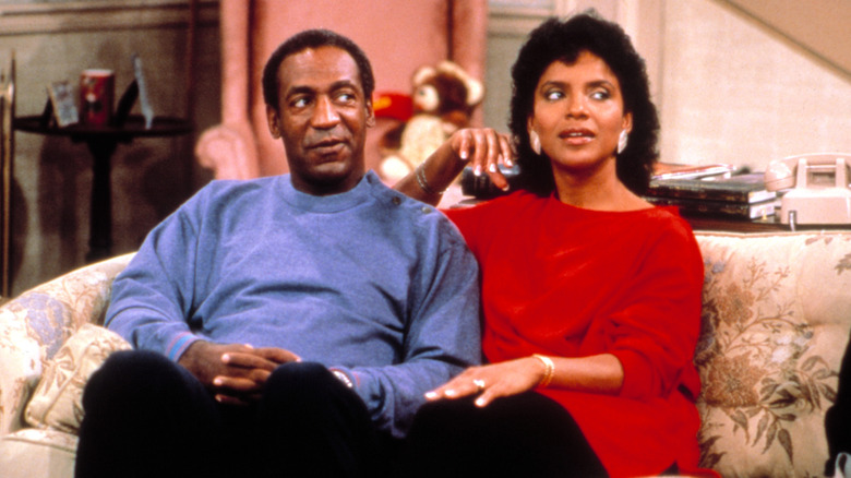 Cliff and Clair sitting on the couch together in "The Cosby Show"
