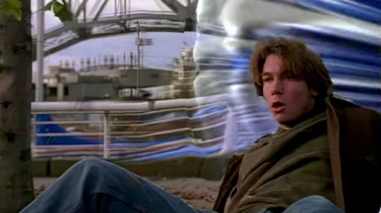 Quinn in front of a rippling space/time wormhole, from Sliders