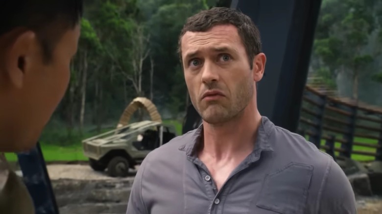 Jim on Terra Nova, standing in front of a futuristic vehicle, looking up