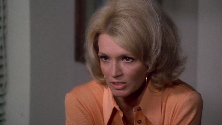 Angie Dickinson as Sgt. Pepper on Police Woman, in an orange shirt