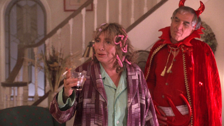 Man dressed as the Devil and a woman smoking