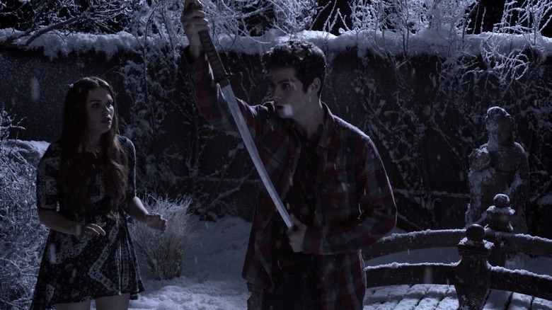 Lydia and Stiles with a sword