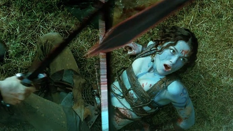 Blue Guinevere looks up at swords