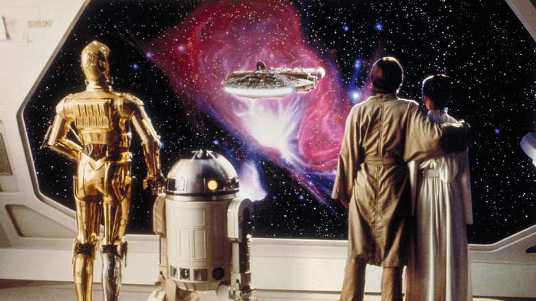 Luke, Leia, R2-D2, and C-3PO watching the Millennium Falcon fly away at the end of "The Empire Strikes Back" (1980)