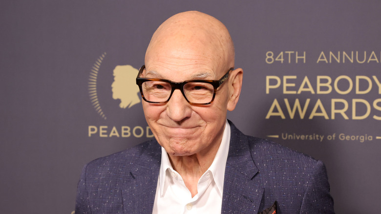 Patrick Stewart wearing glasses and smiling