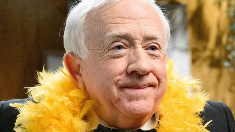 Leslie Jordan wearing a feather boa