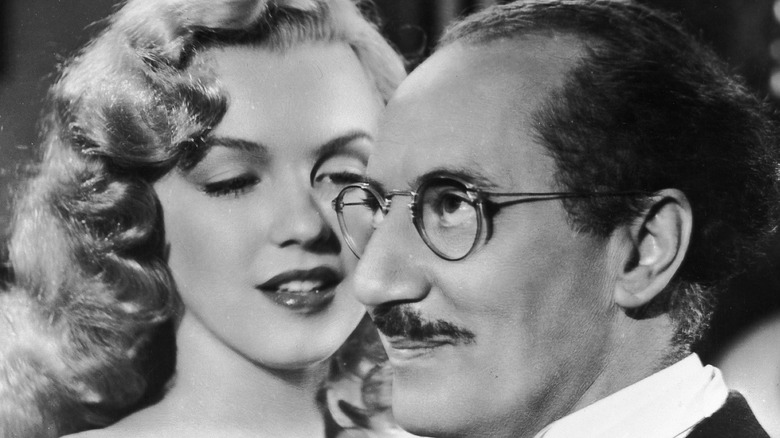 Marilyn Monroe gets close to Groucho Marx