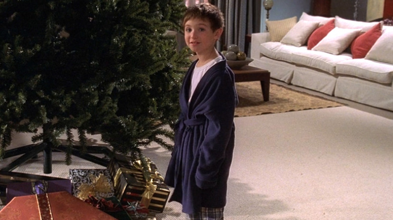 Kevin standing next to a Christmas tree wearing a robe