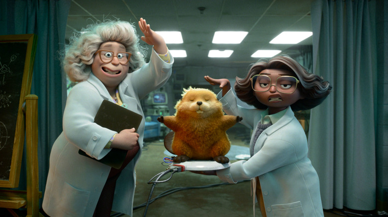 Dr. Sam and Nisha standing next to one of their hoppers