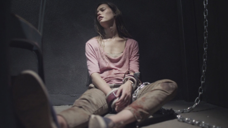 Lucie is chained to a wall in "Martyrs" (2015)