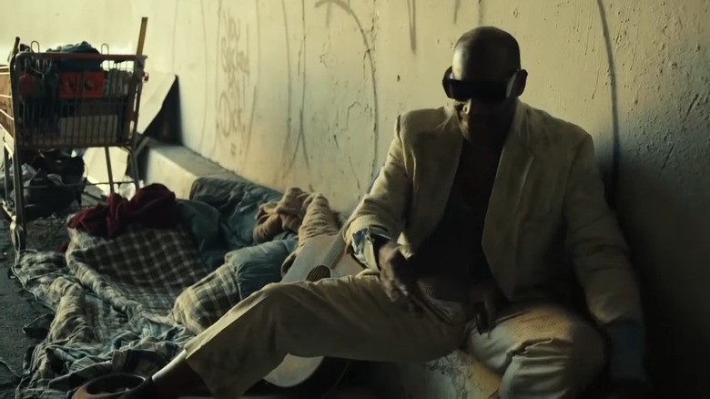 A weary man lying in the street in Frankenstein (2015)