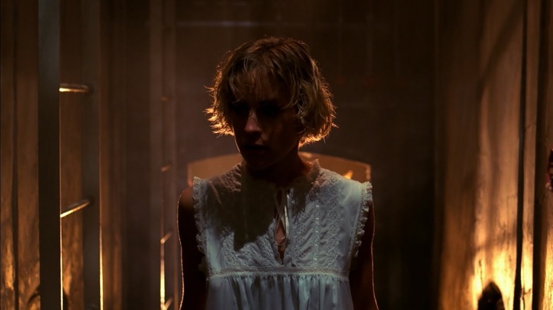 Tina Gray walks down hallway