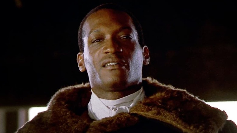 Candyman hovers above bed