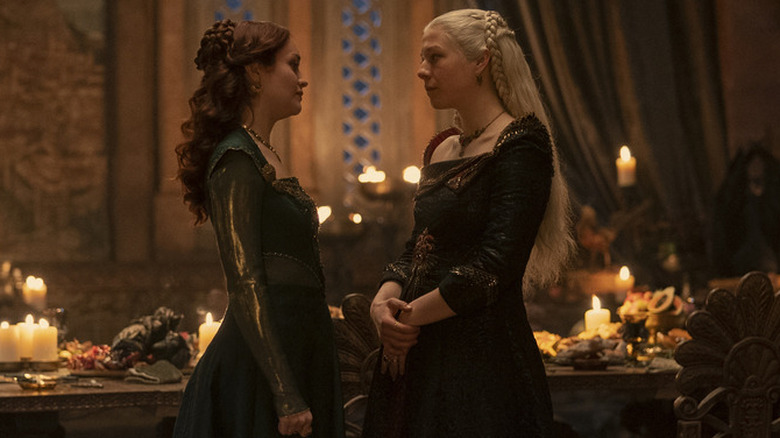 Alicent and Rhaenyra talking to each other in front of the dining table