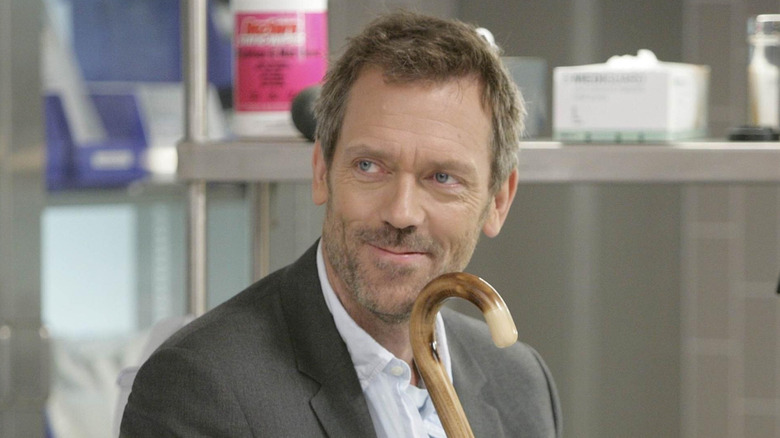 Gregory House holding his cane and smiling (2008)
