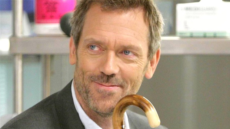 Gregory House holding his cane and smiling (2008)