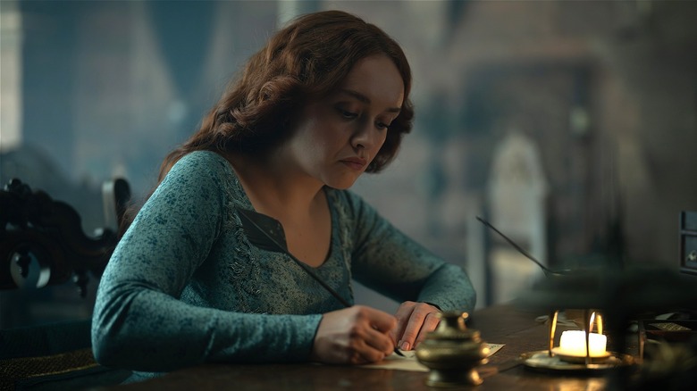 Alicent writing at a table in House of the Dragon
