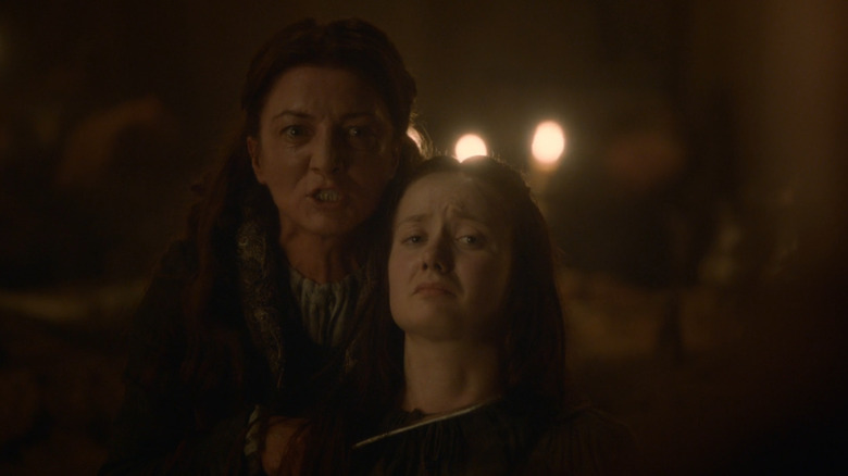 Catelyn Stark holds a knife to Walder Frey's wife
