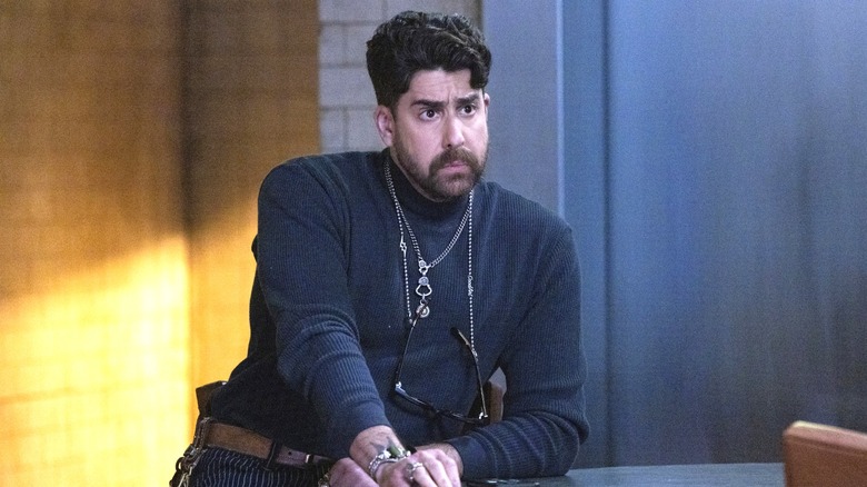 Adam Goldberg as Harry Keshegian leaning against desk on The Equalizer 