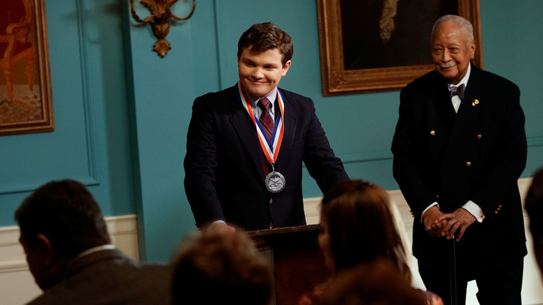 Sean accepts a medal in 