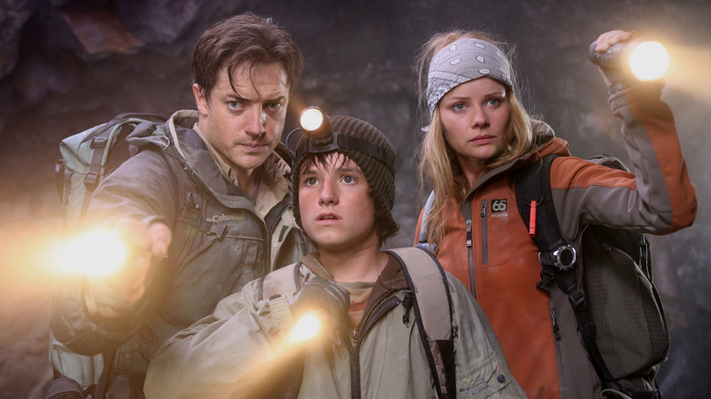 Trevor, Sean, and Hannah shine flashlights ahead