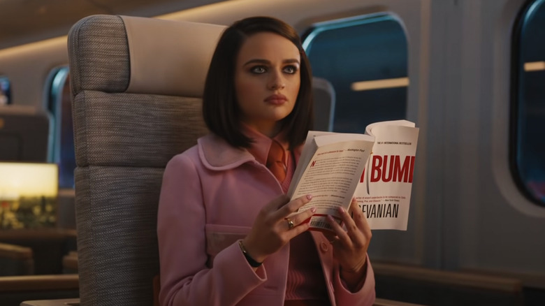 Joey King reads a book on the train