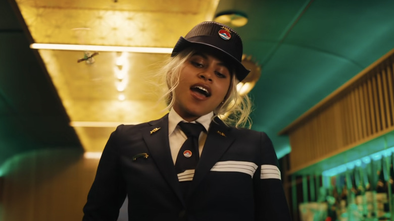 Blonde Zazie Beetz wearing a train attendant uniform