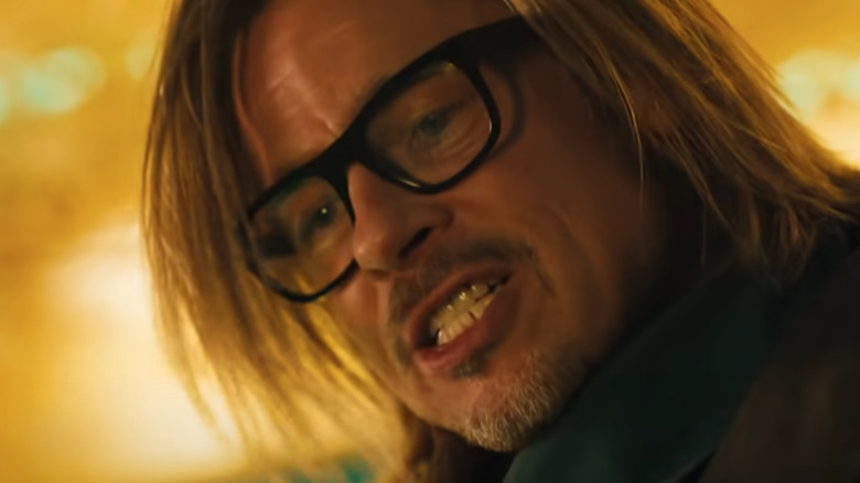 Brad Pitt gritting his teeth wearing glasses