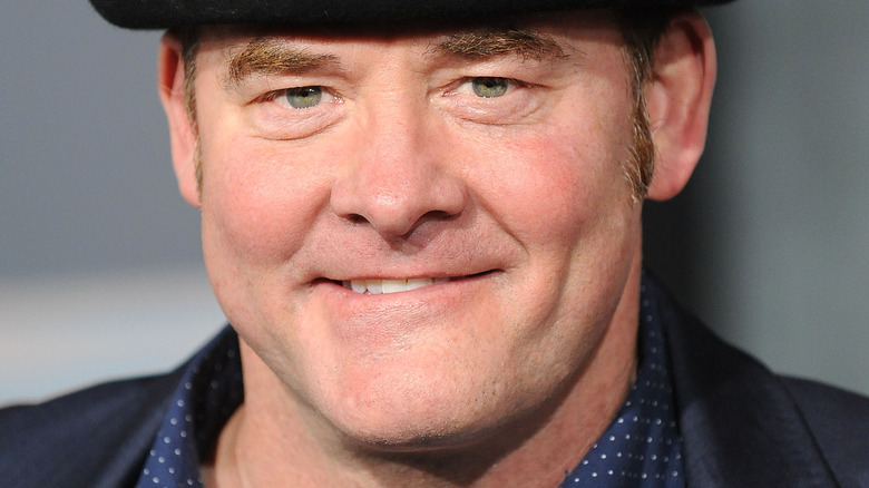 David Koechner in black hat smiling