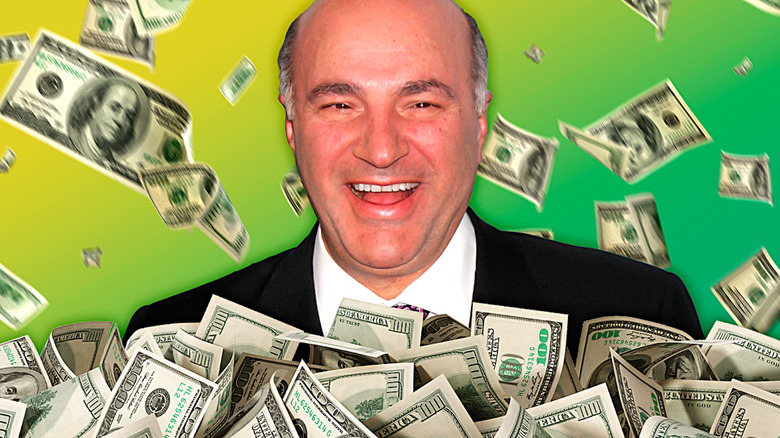 Kevin O'Leary smiles with money