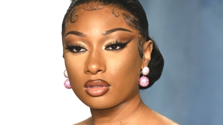 Megan Thee Stallion wearing dangly pink earrings