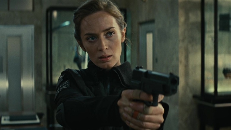 Rita Vrtaski holding gun