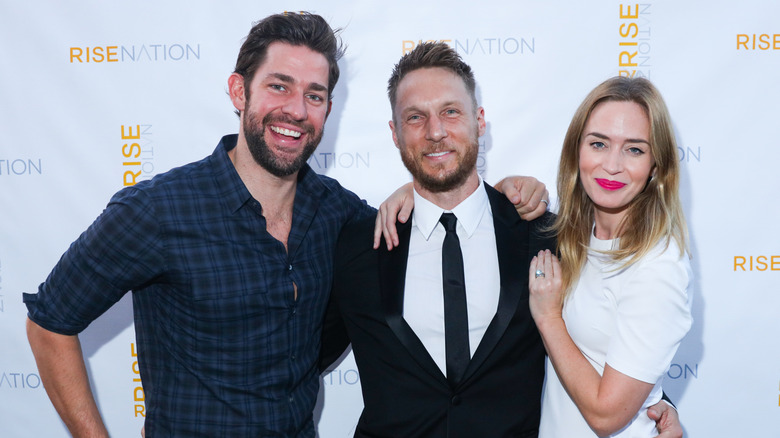 Emily Blunt and Jason Walsh and John Krasinski smile