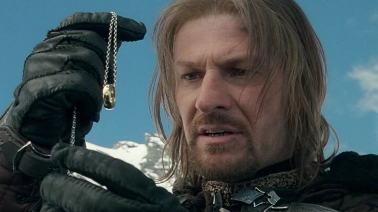 Boromir looks at the One Ring on its chain in "The Fellowship of the Ring"