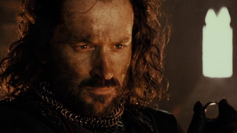 Isildur looks at the One Ring in "The Lord of the Rings: The Fellowship of the Ring" (2001)