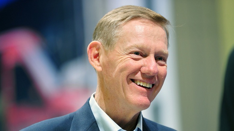 The former Ford CEO Alan Mulally photographed wearing a blue suit with a ford pin