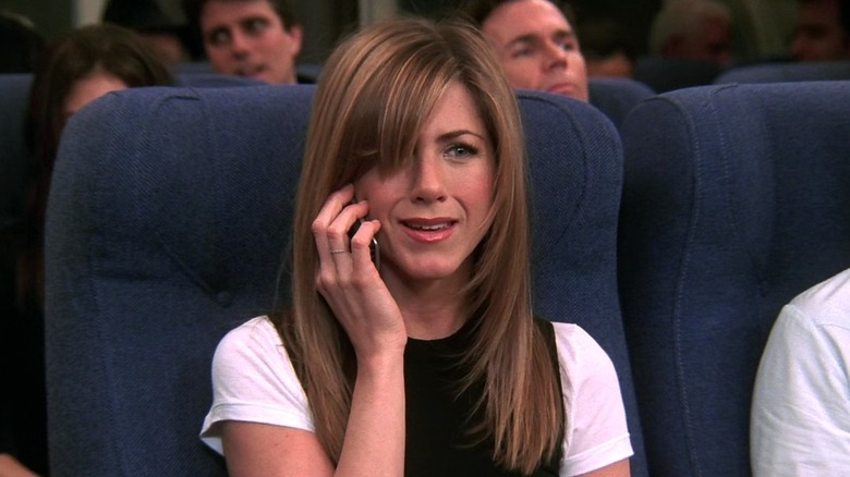 Rachel using phone on plane 